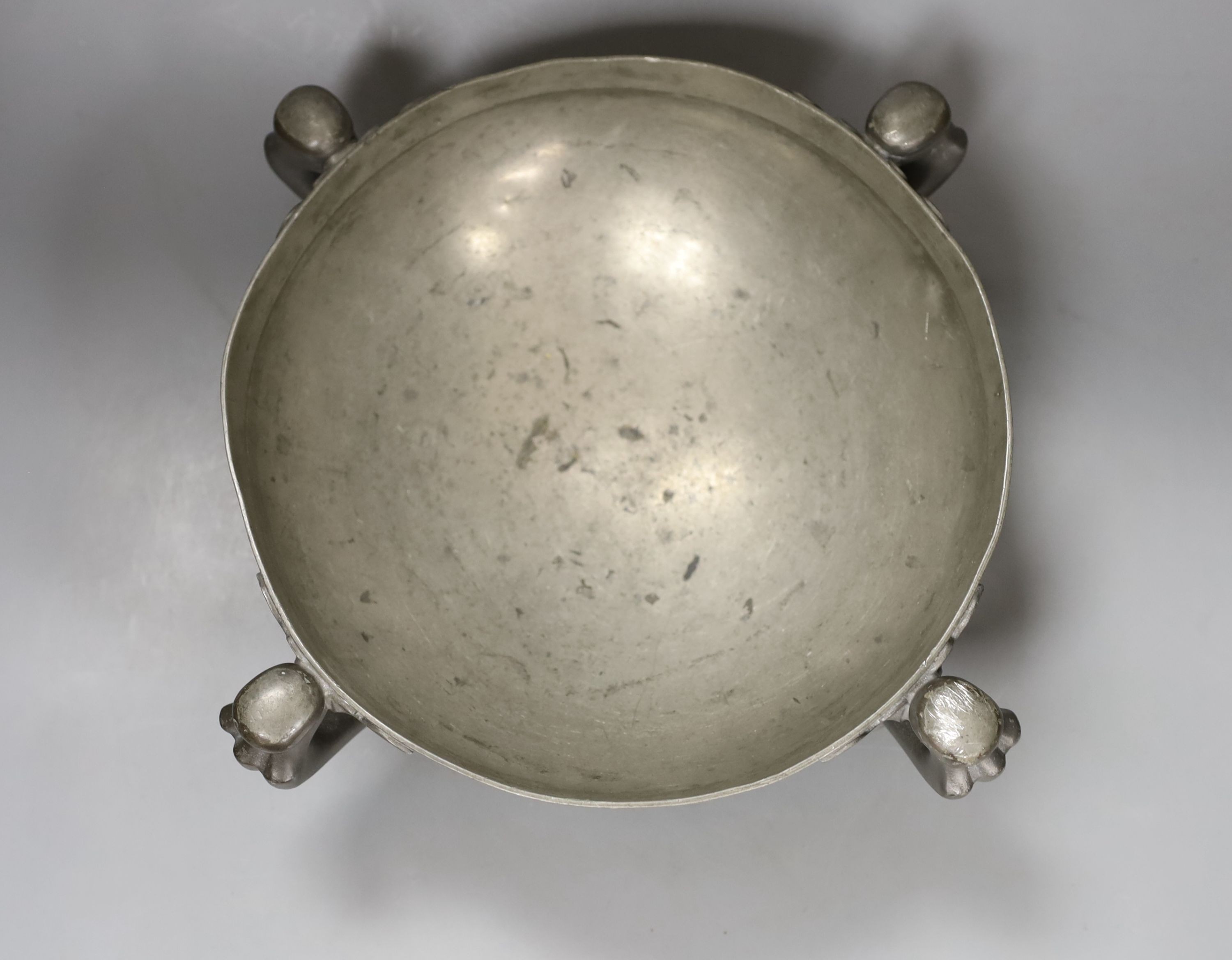 Oliver Baker for Liberty’s, a Tudric pewter fruit bowl, shape 067, on stylised feet, 26cm. diam.